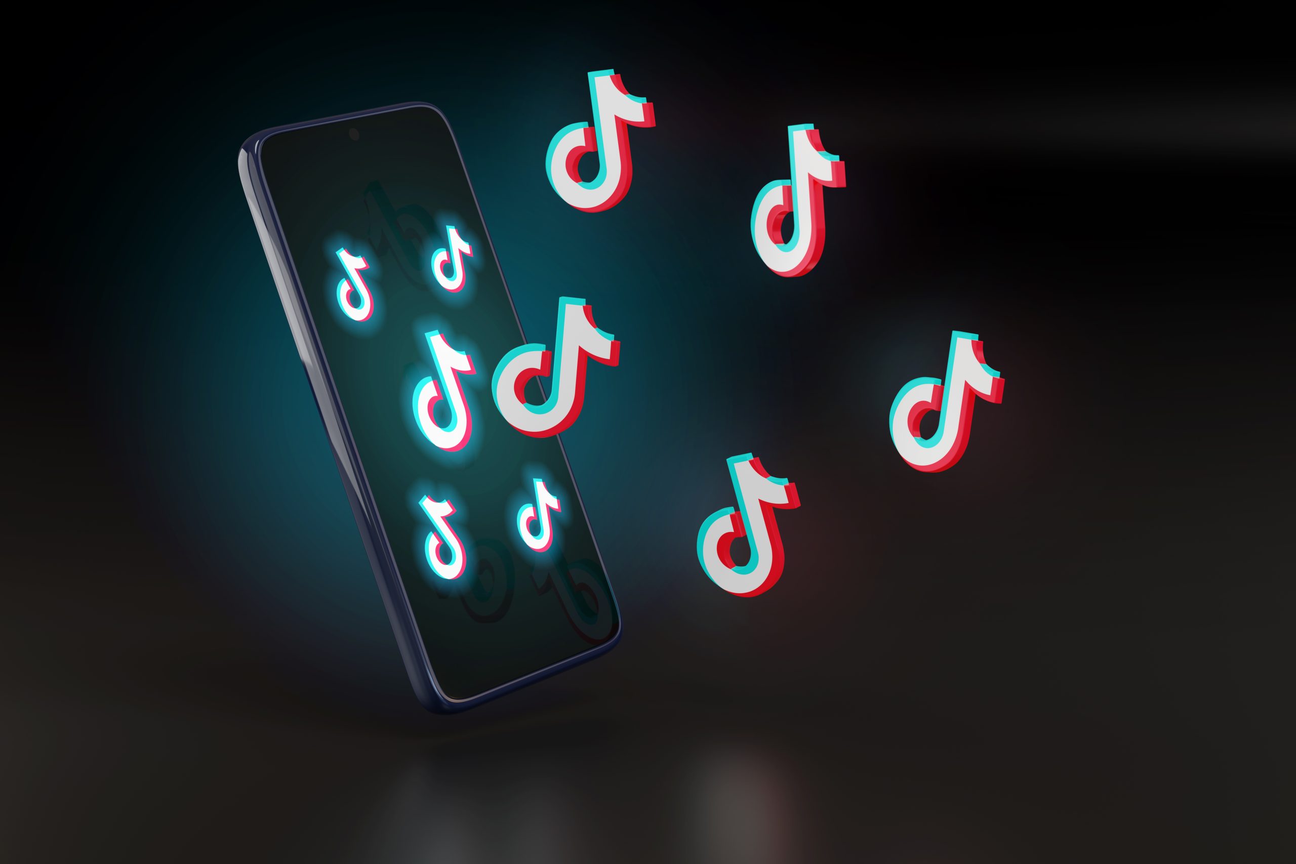 3D-illustratie van een smartphone waar meerdere TikTok-logo's uit lijken te zweven, als symbool voor de groeiende aanwezigheid van TikTok-content.
